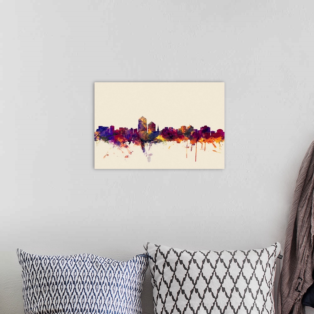 A bohemian room featuring Contemporary artwork of the Albuquerque city skyline in watercolor paint splashes.