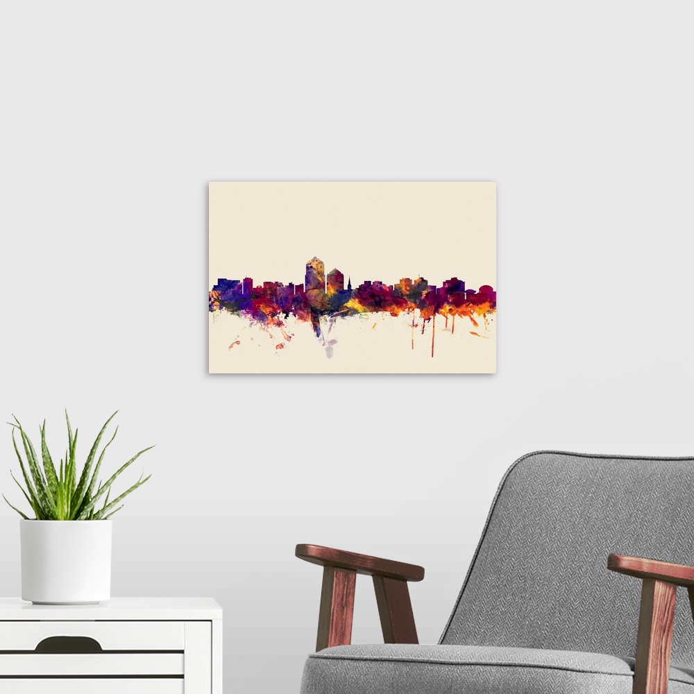 A modern room featuring Contemporary artwork of the Albuquerque city skyline in watercolor paint splashes.