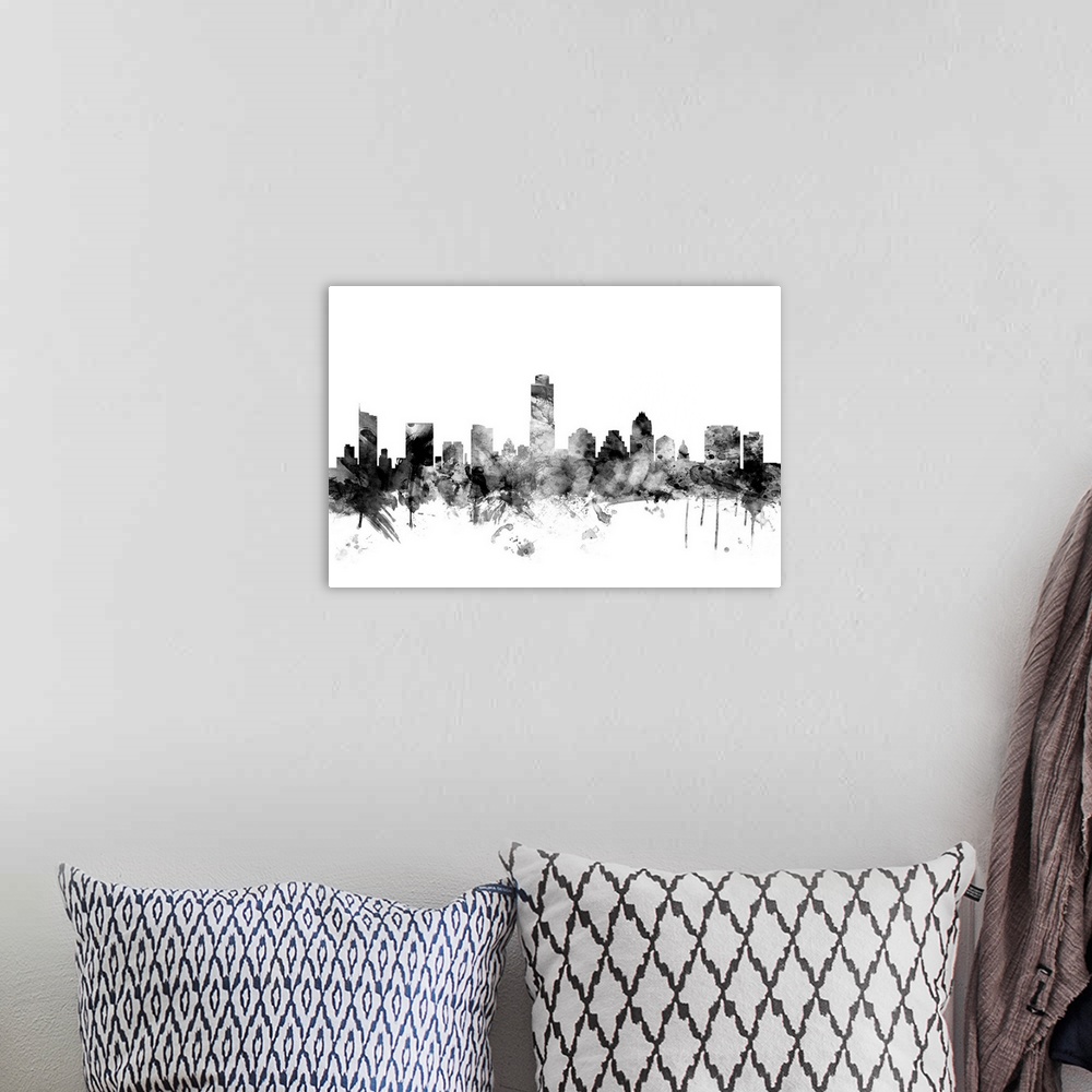 A bohemian room featuring Contemporary artwork of the Austin city skyline in black watercolor paint splashes.