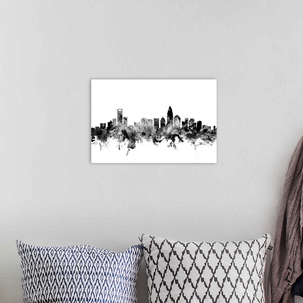A bohemian room featuring Contemporary artwork of the Charlotte city skyline in black watercolor paint splashes.