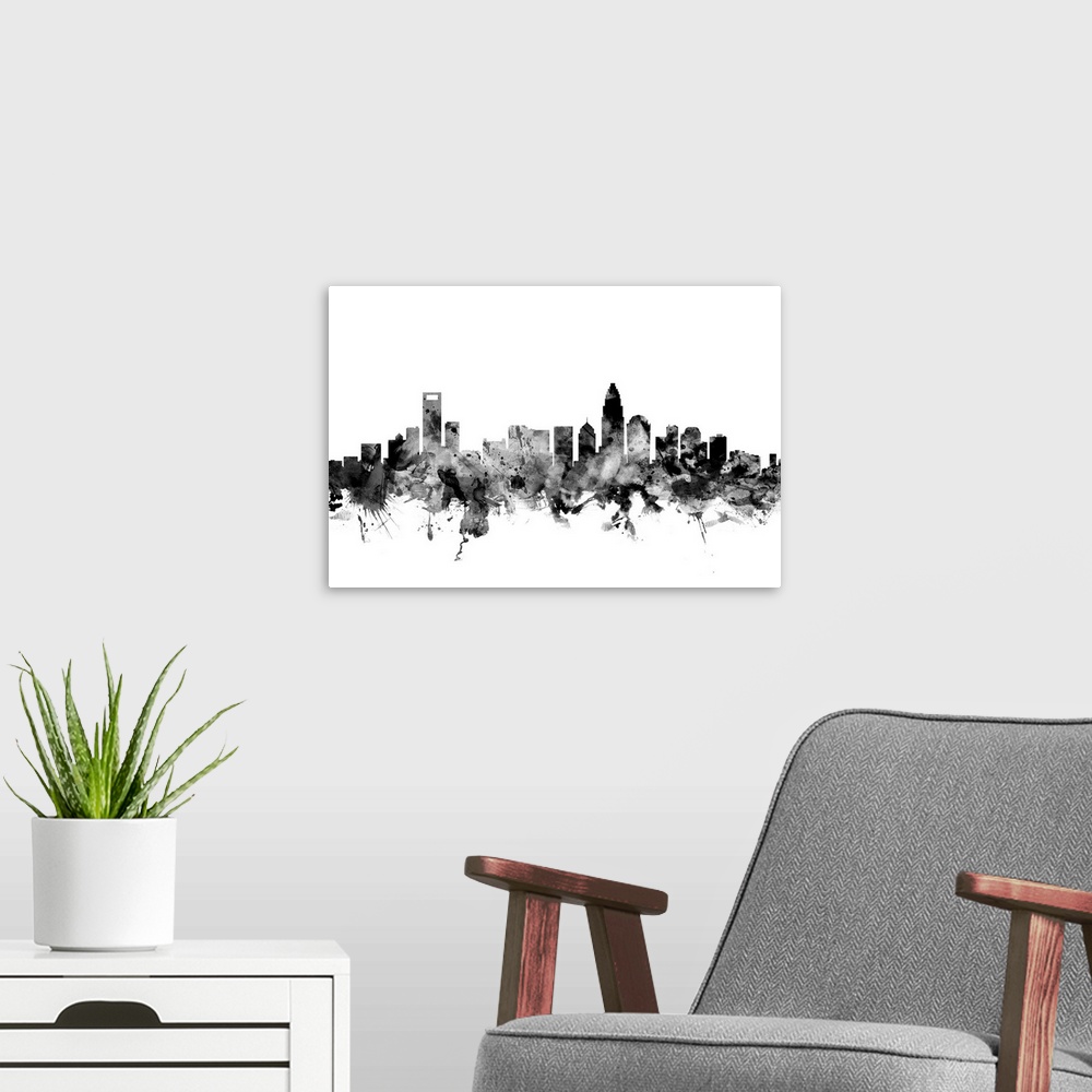 A modern room featuring Contemporary artwork of the Charlotte city skyline in black watercolor paint splashes.