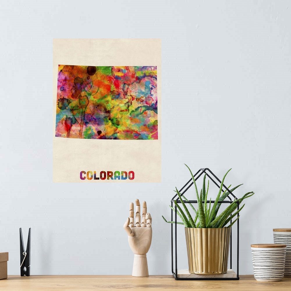 A bohemian room featuring Contemporary piece of artwork of a map of Colorado made up of watercolor splashes.