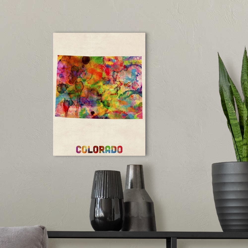 A modern room featuring Contemporary piece of artwork of a map of Colorado made up of watercolor splashes.