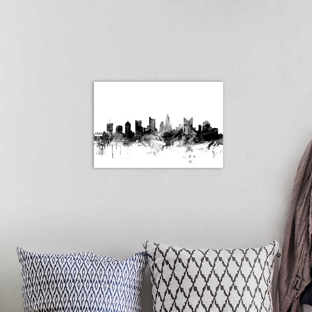 A bohemian room featuring Contemporary artwork of the Columbus city skyline in black watercolor paint splashes.