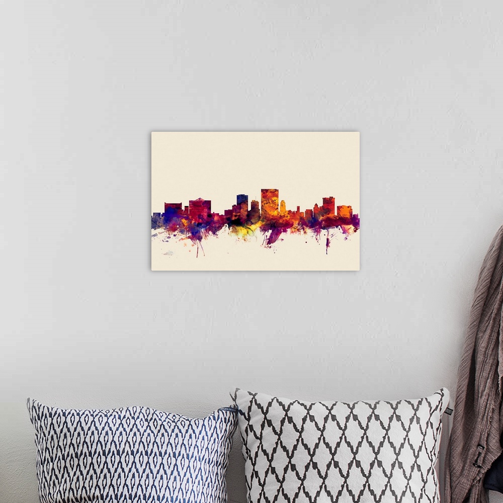 A bohemian room featuring Contemporary artwork of the El Paso city skyline in watercolor paint splashes.