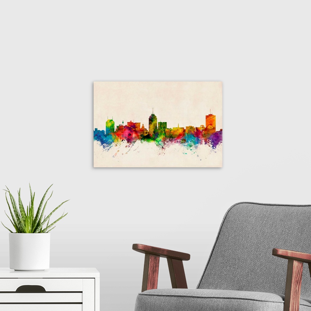 A modern room featuring Contemporary piece of artwork of the Fresno skyline made of colorful paint splashes.