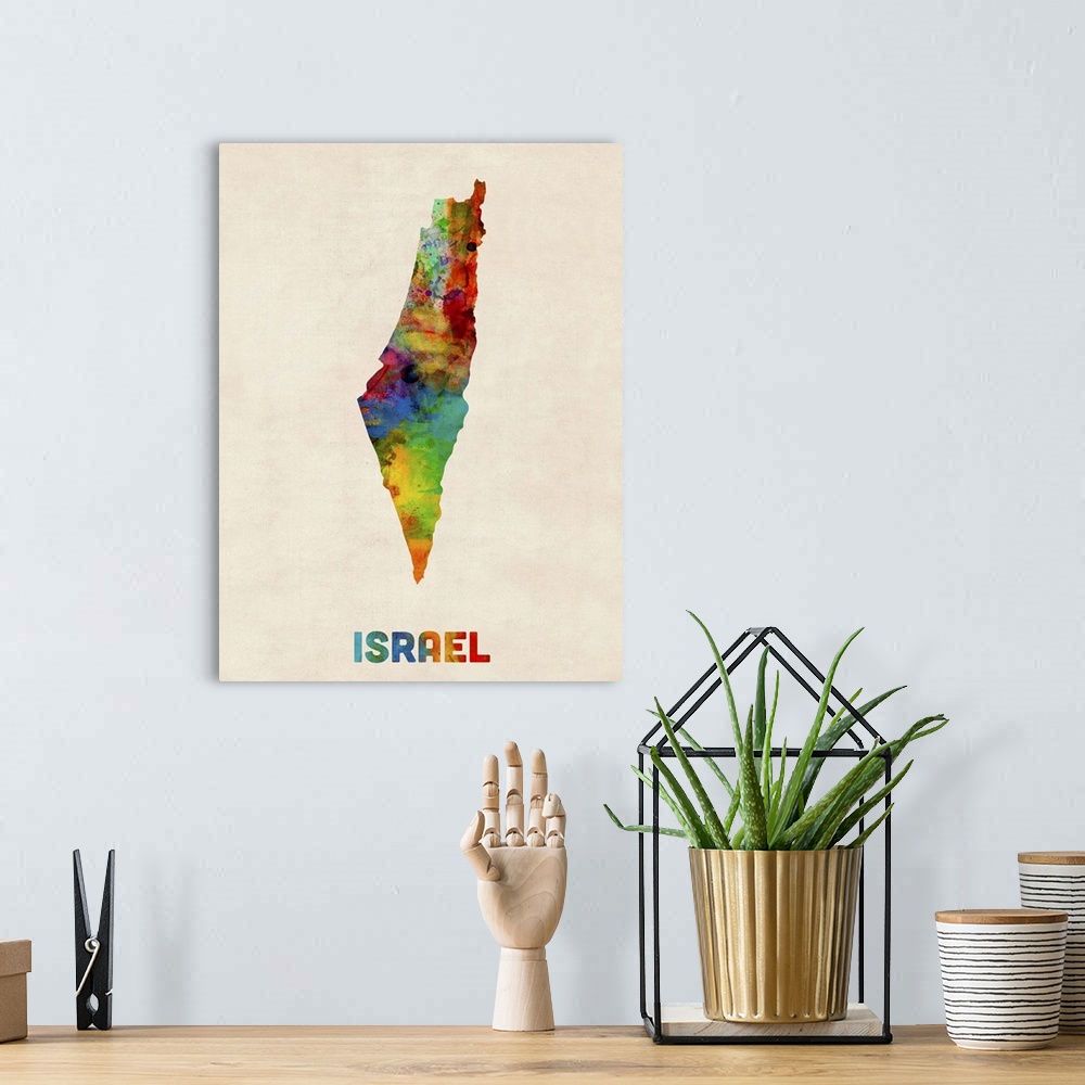 A bohemian room featuring Contemporary piece of artwork of a map of Israel made up of watercolor splashes.