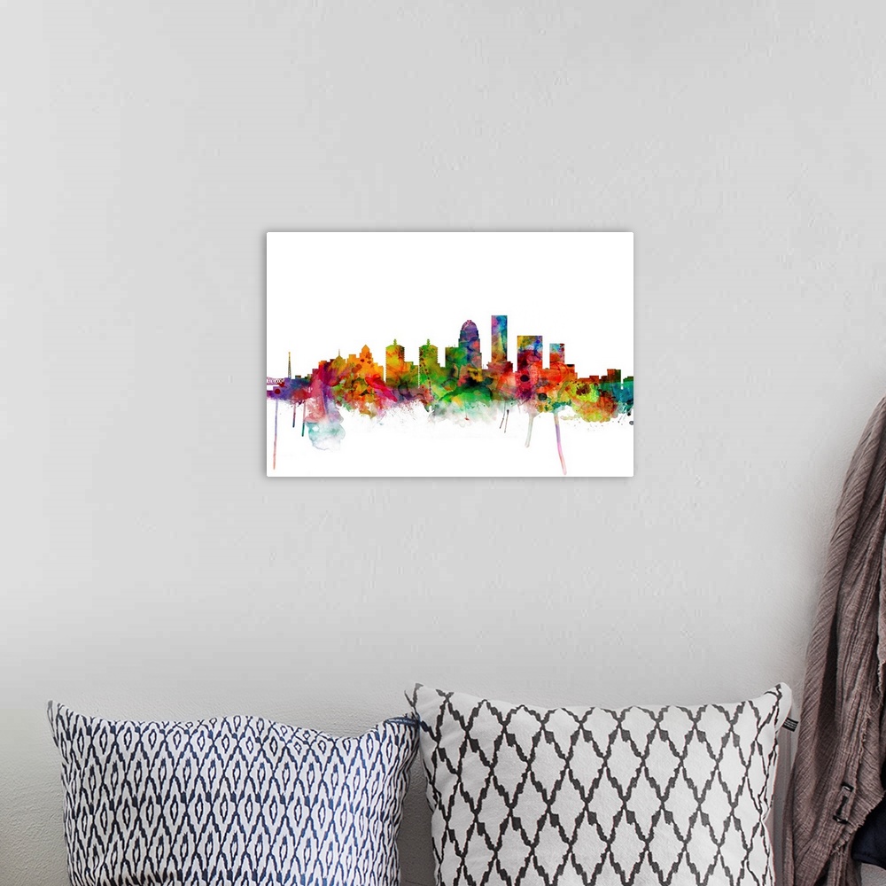 A bohemian room featuring Colorful watercolor splattered silhouetted of the Louisville city skyline.