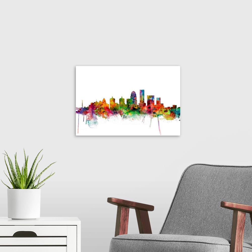 A modern room featuring Colorful watercolor splattered silhouetted of the Louisville city skyline.