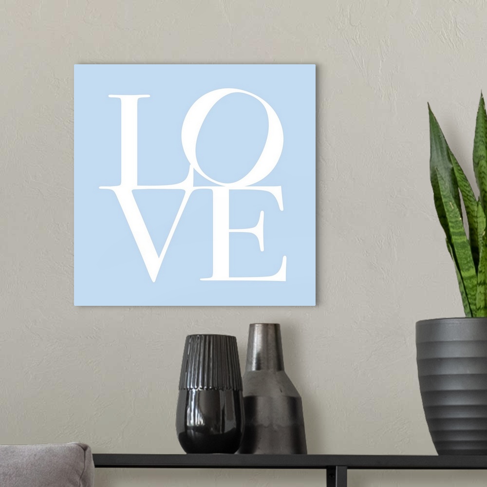 A modern room featuring LOVE, typography text art print and canvas print, with the word LOVE written against a baby blue ...