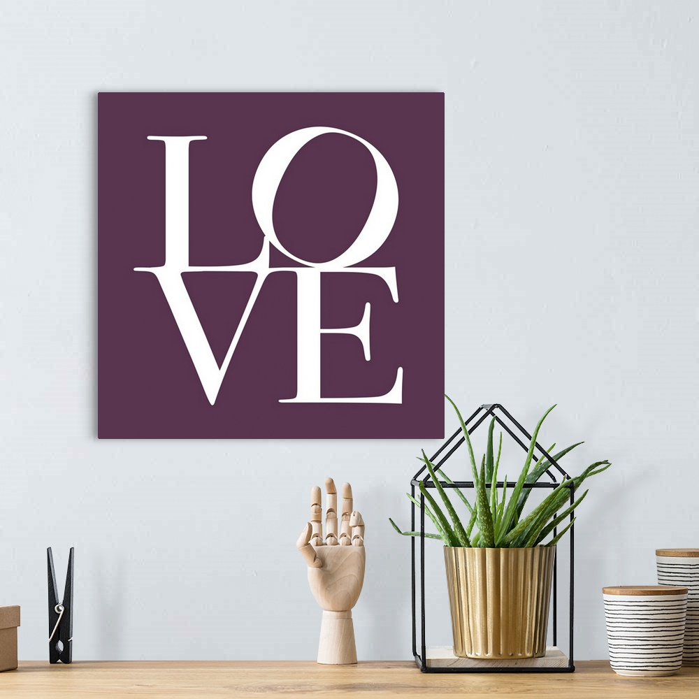 A bohemian room featuring LOVE, typography text art print and canvas print, with the word LOVE written against a Mulberry P...