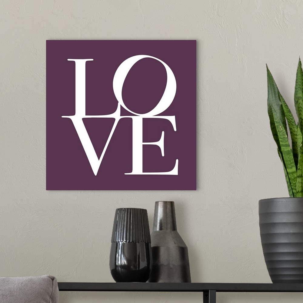 A modern room featuring LOVE, typography text art print and canvas print, with the word LOVE written against a Mulberry P...