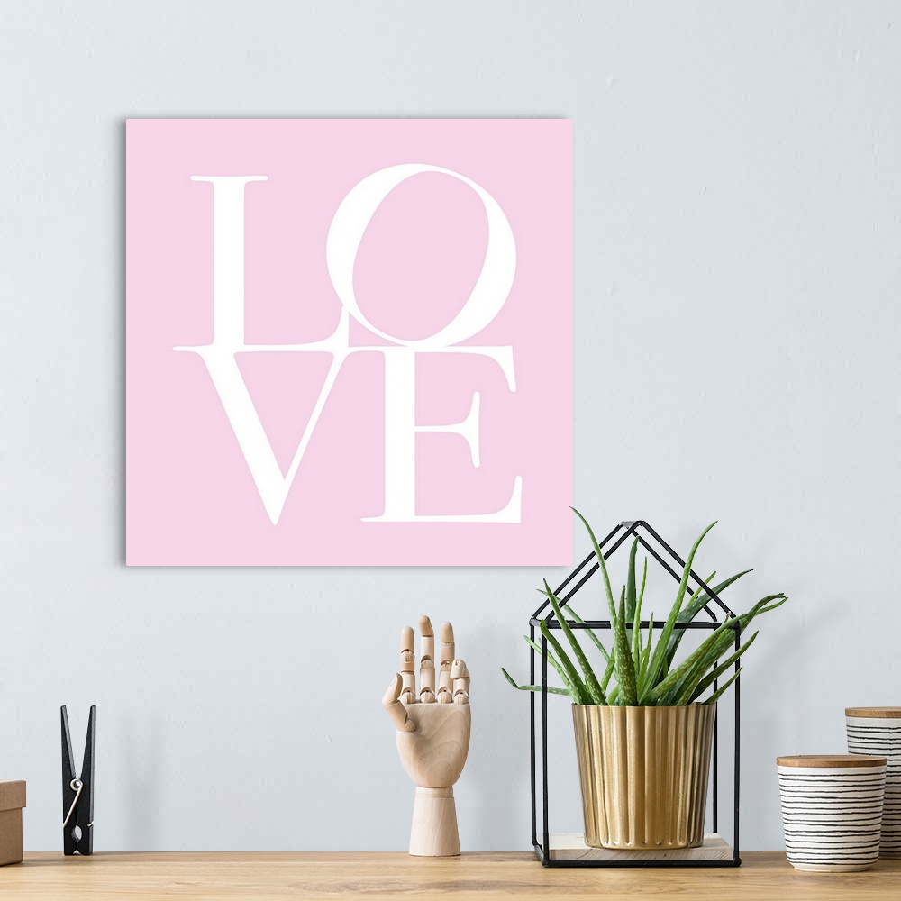 A bohemian room featuring Oversized, square, contemporary art  of the word "LOVE" written against a pink background. The wo...
