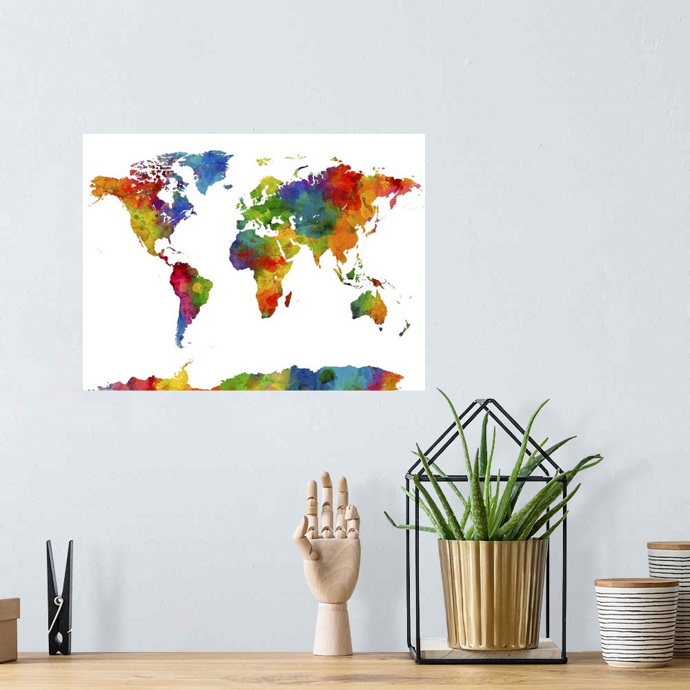 A bohemian room featuring A watercolor art map of the world against a white background.