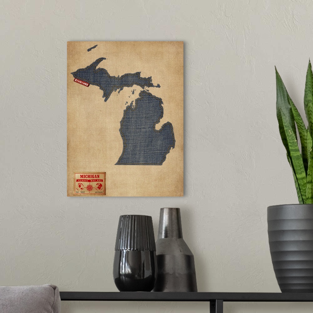 A modern room featuring Contemporary artwork of the state of Michigan made of denim, against a rustic background.