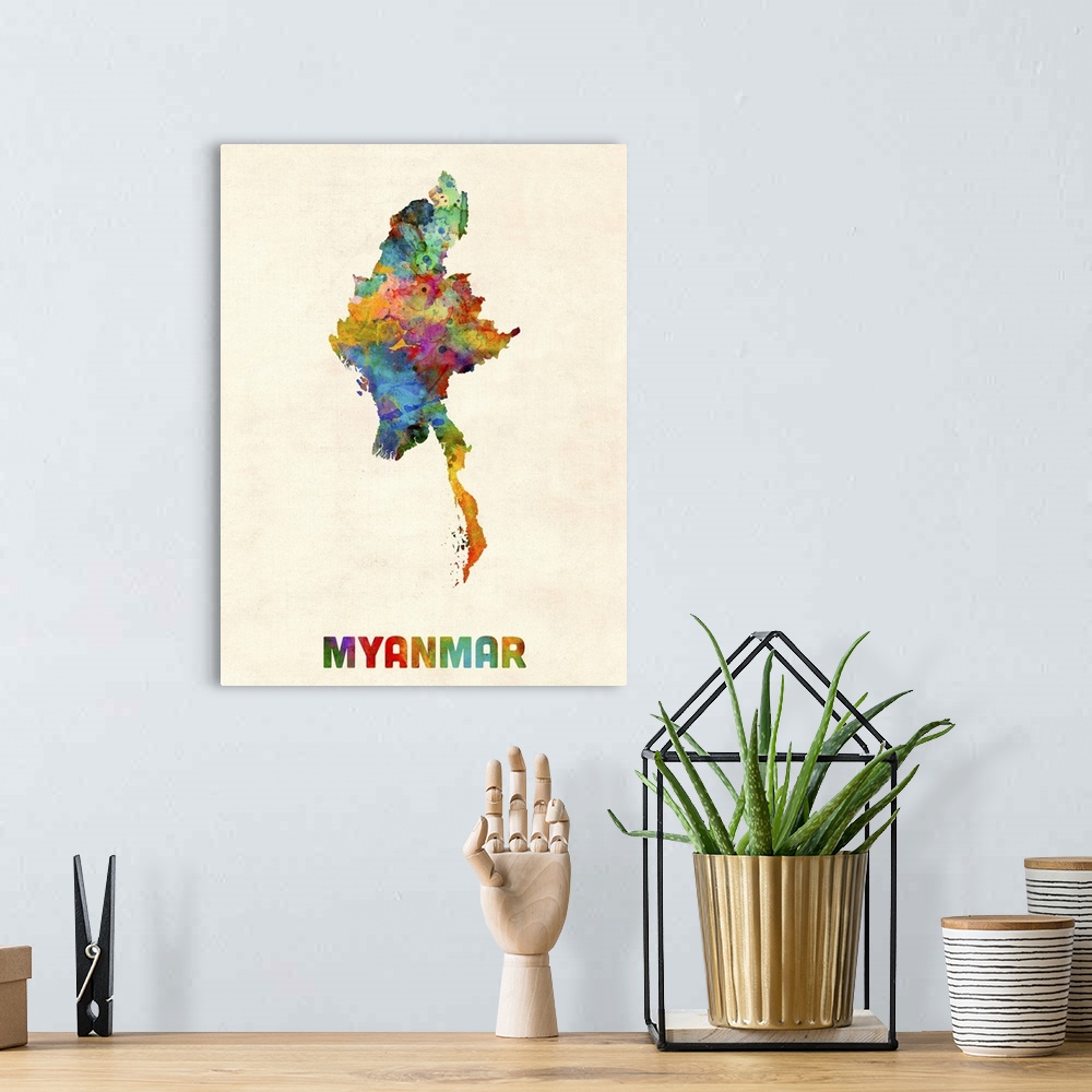 A bohemian room featuring Colorful watercolor art map of Myanmar against a distressed background.