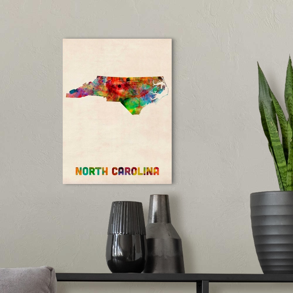 A modern room featuring Contemporary piece of artwork of a map of North Carolina made up of watercolor splashes.