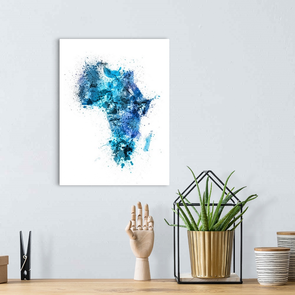 A bohemian room featuring Contemporary art map of Africa made up of blue watercolor paint splashes.