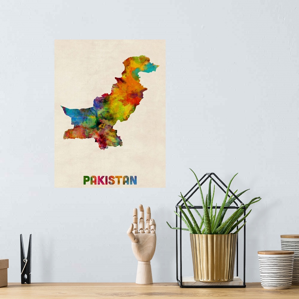 A bohemian room featuring Contemporary piece of artwork of a map of Pakistan made up of watercolor splashes.