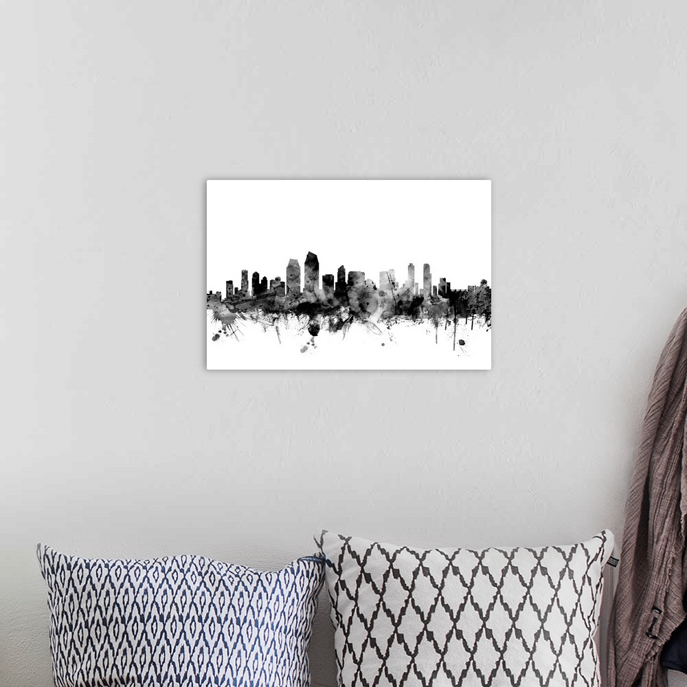 A bohemian room featuring Contemporary artwork of the San Diego city skyline in black watercolor paint splashes.