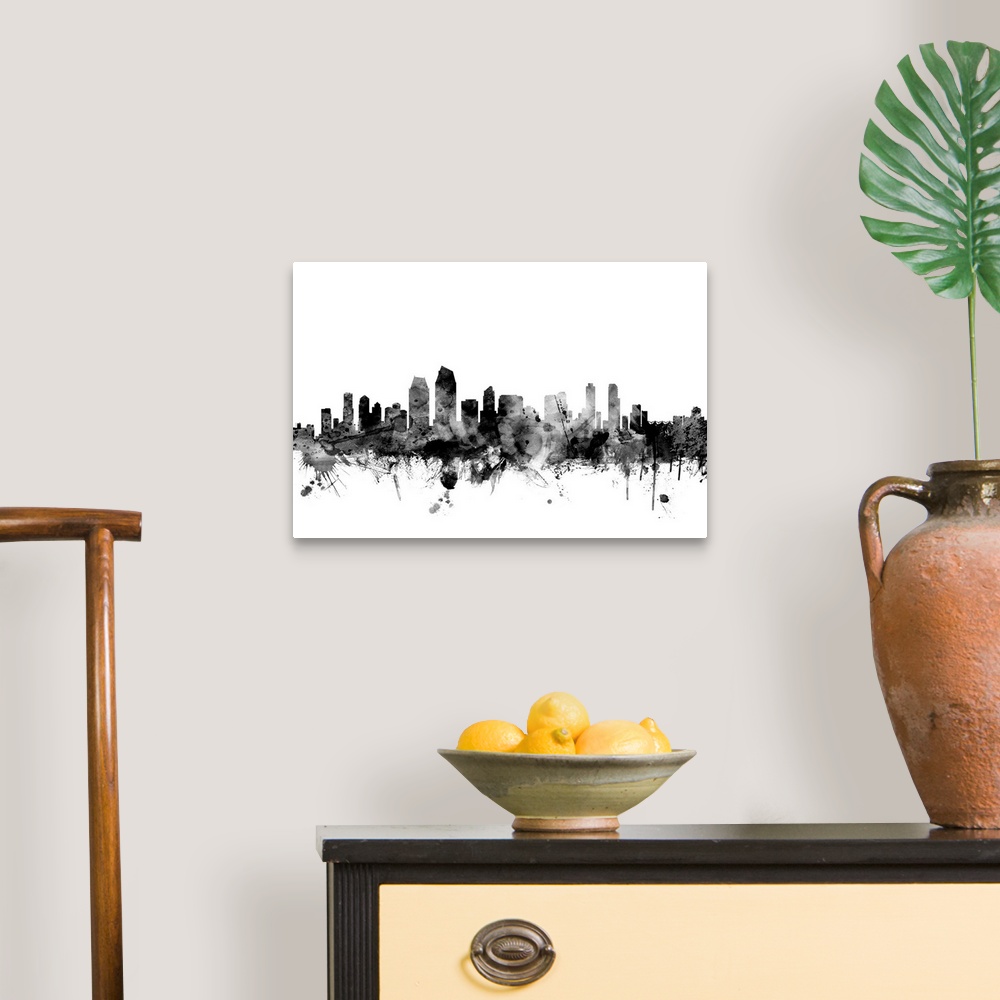 A traditional room featuring Contemporary artwork of the San Diego city skyline in black watercolor paint splashes.