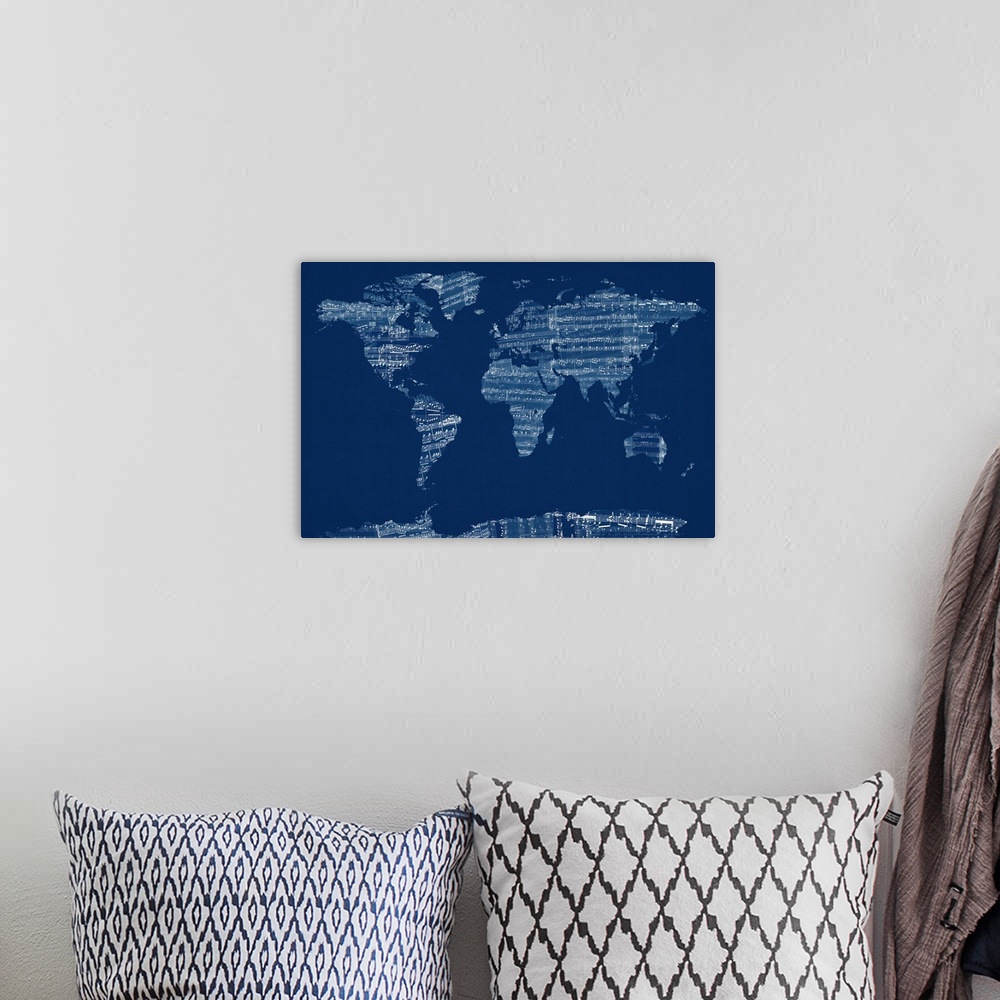 A bohemian room featuring Artwork of the map of the world made sheets from a music book.
