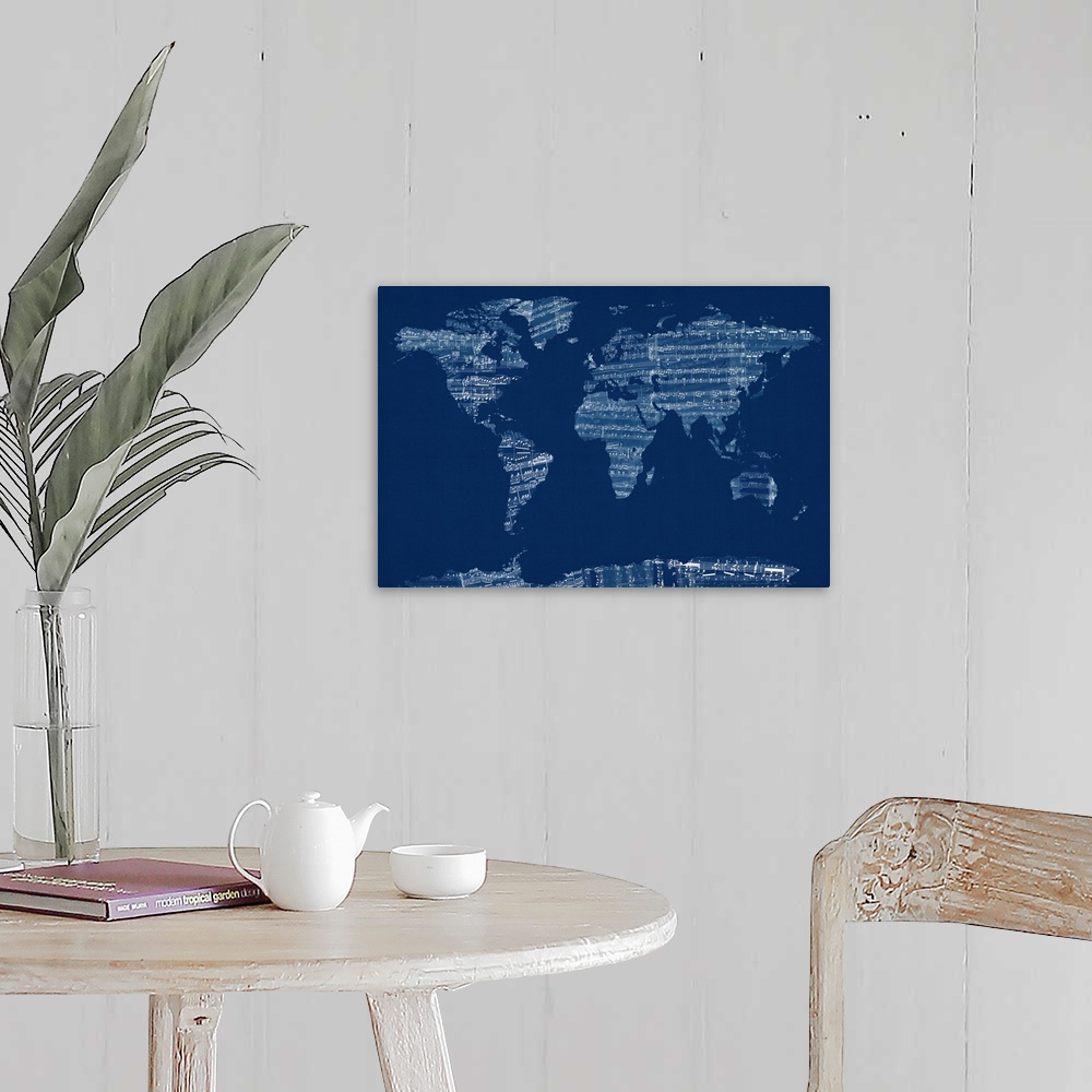 A farmhouse room featuring Artwork of the map of the world made sheets from a music book.