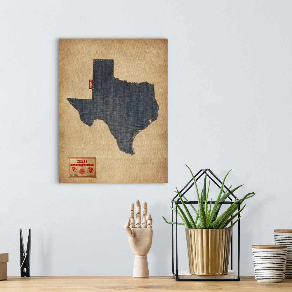 A bohemian room featuring Contemporary artwork of the state of Texas made of denim, against a rustic background.
