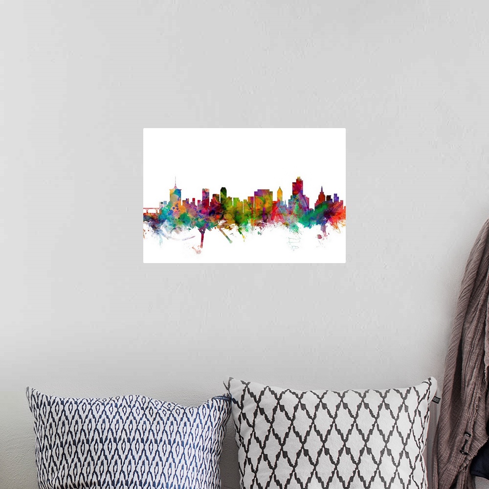 A bohemian room featuring Watercolor artwork of the Tulsa skyline against a white background.