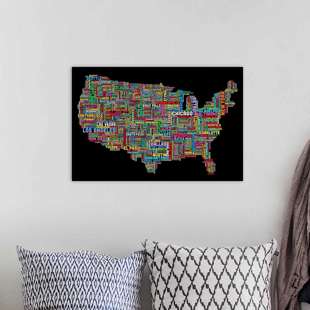 A bohemian room featuring Colorful map of America made of the names of each city that corresponds to its location.