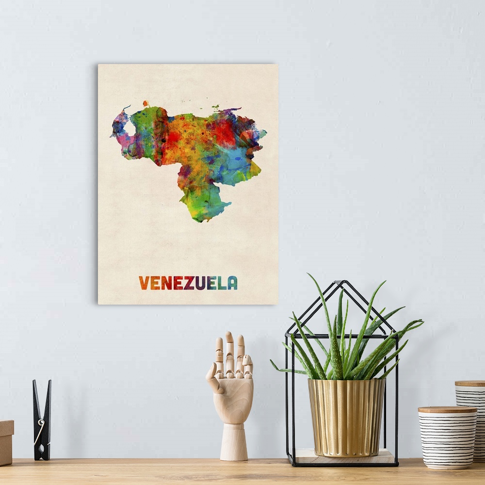 A bohemian room featuring Watercolor art map of the country Venezuela against a weathered beige background.