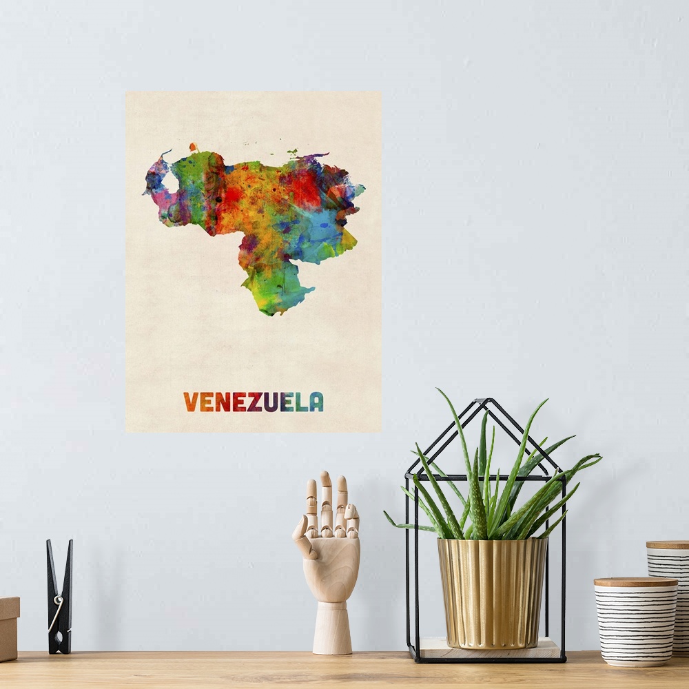 A bohemian room featuring Watercolor art map of the country Venezuela against a weathered beige background.