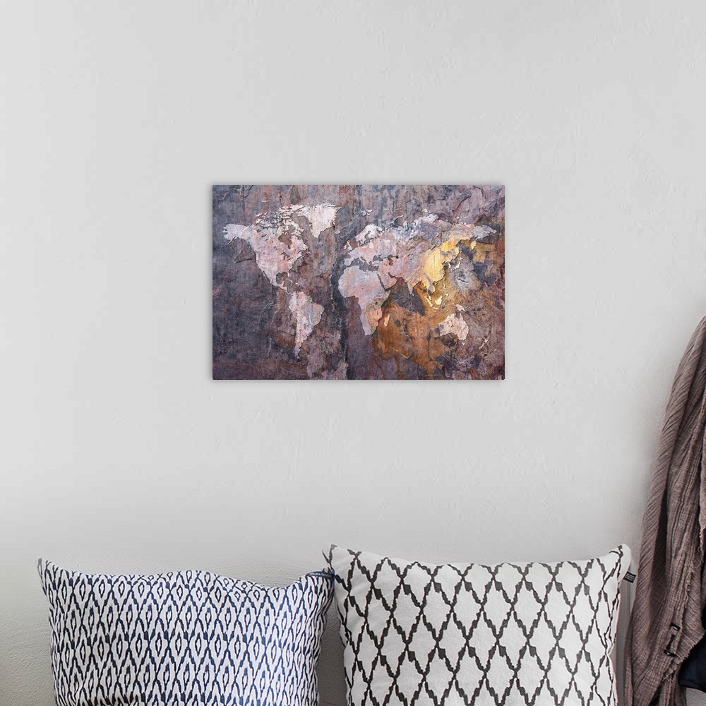 A bohemian room featuring Huge canvas art depicts a map of Earth laid over a roughly textured rock face.
