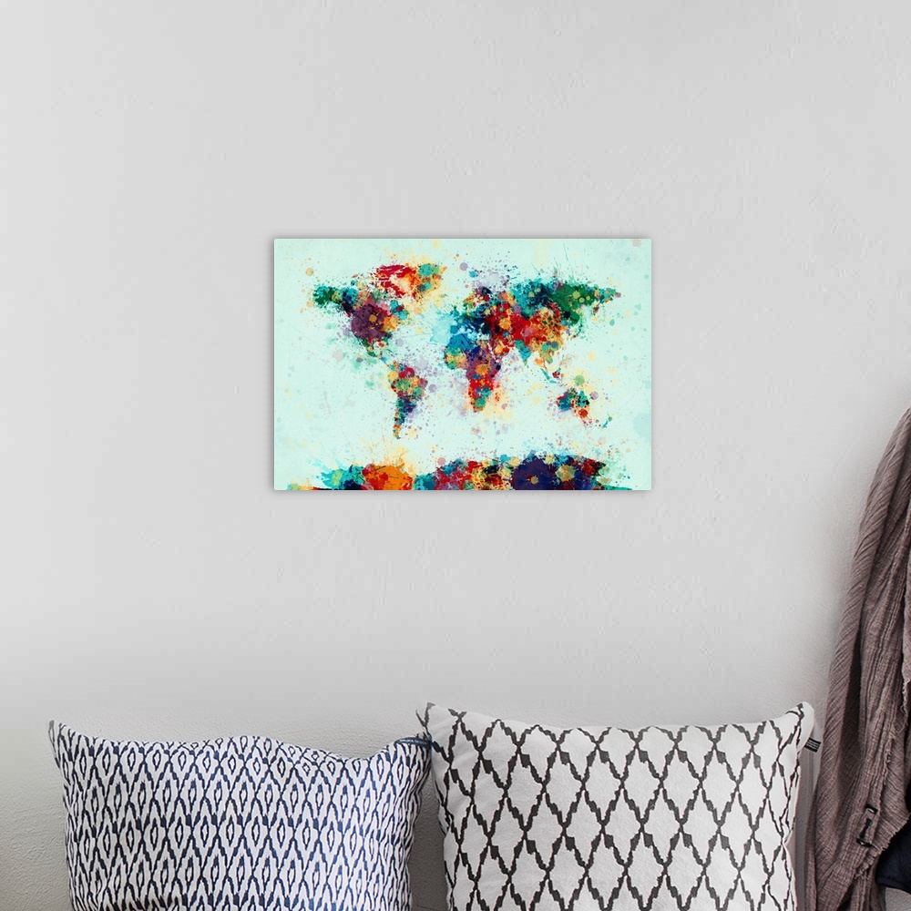 A bohemian room featuring Contemporary world map artwork made of bright watercolor paint splashes.