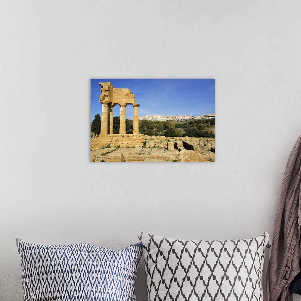A bohemian room featuring Agrigento Greek ruins, modern city in the background, Sicily, Italy.
