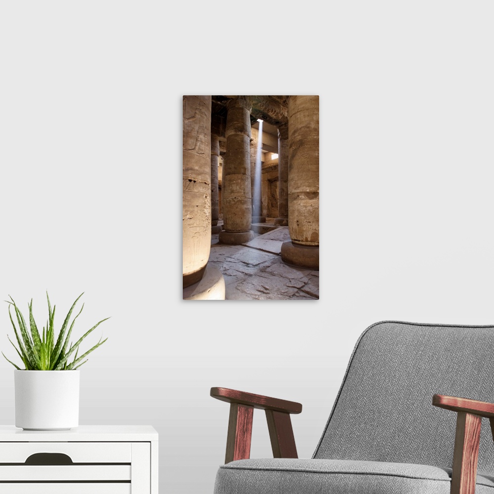 A modern room featuring Luxor, temple of Abydos, ray of sulight entering the temple from a crack in the ceiling