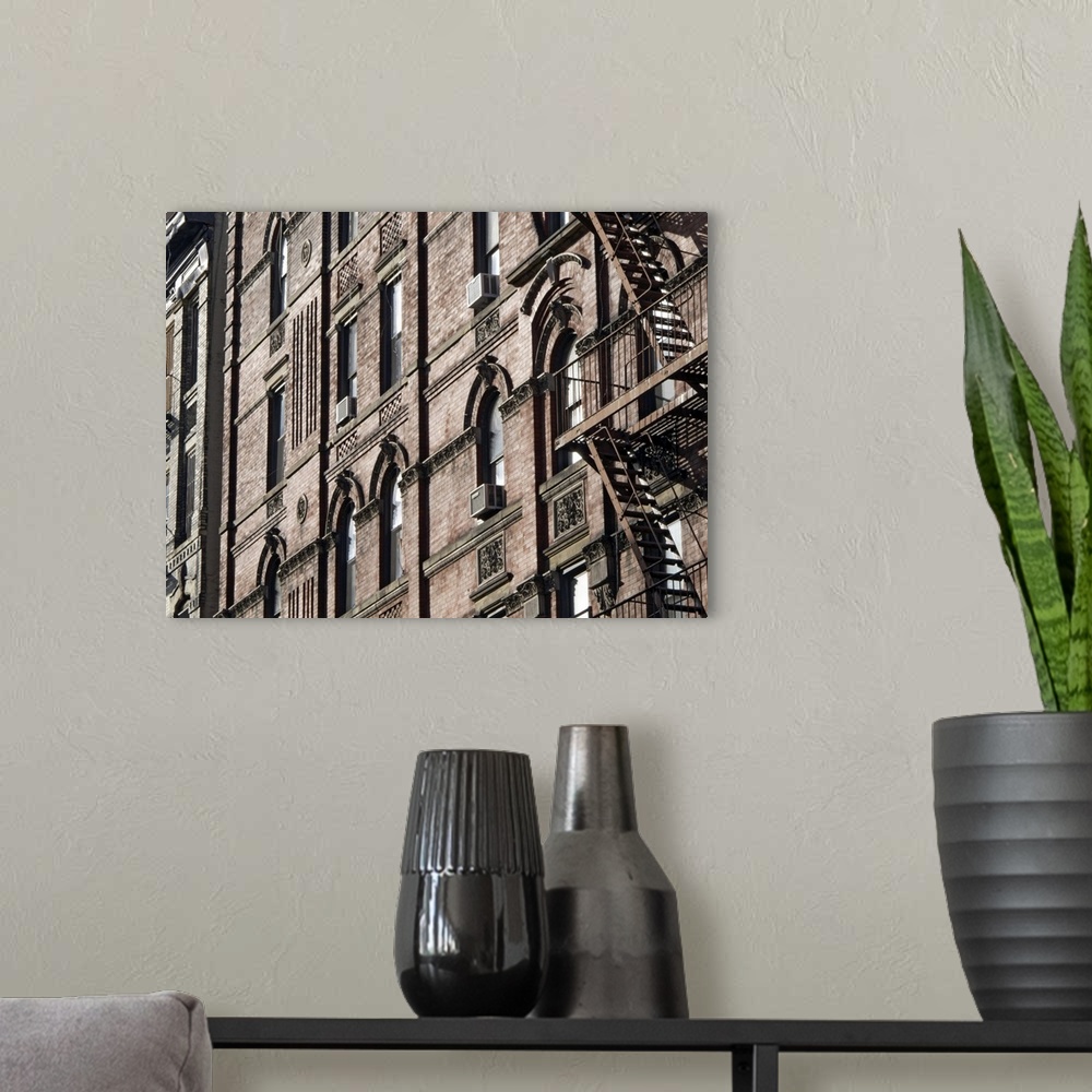 A modern room featuring This is a horizontal photograph of the faoade of a brick buildingos window, window mounted AC uni...