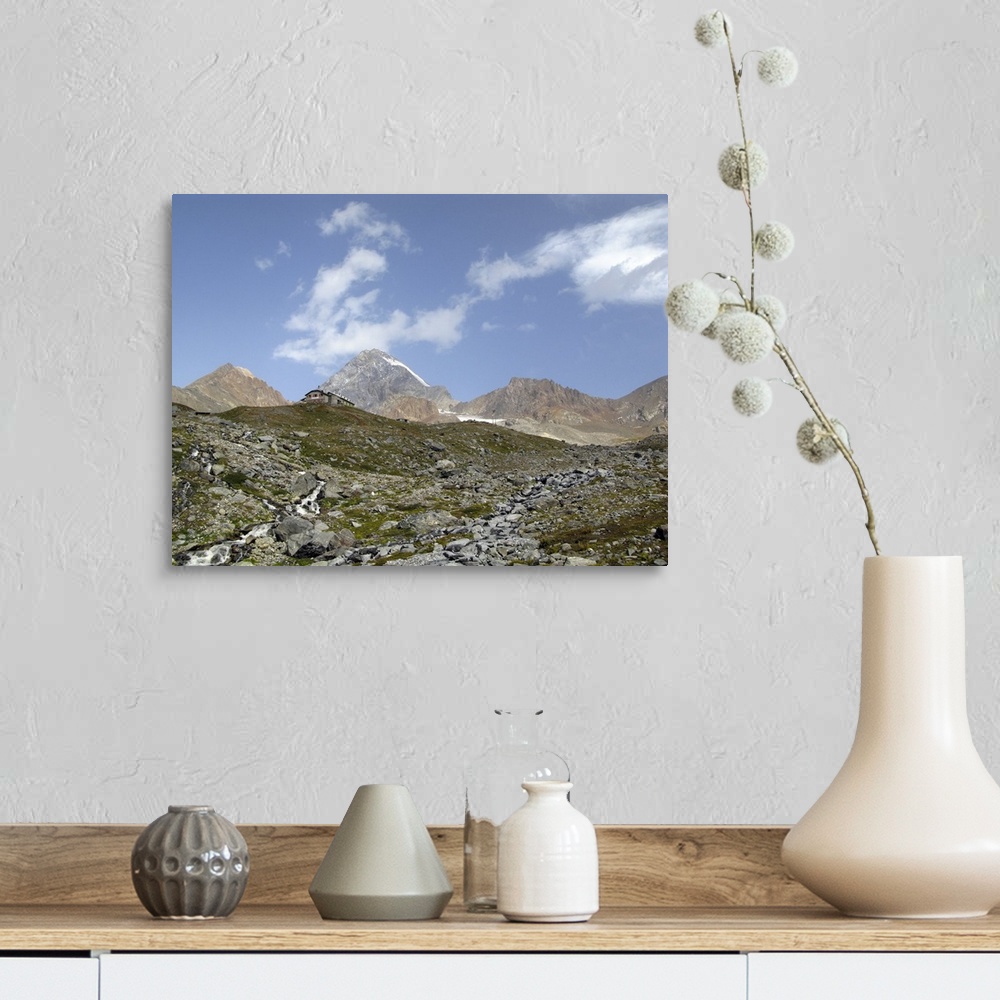 A farmhouse room featuring Pizzini hut (2706 m) in the upper Sondrio province, Italy. In the background, the tallest peak is...