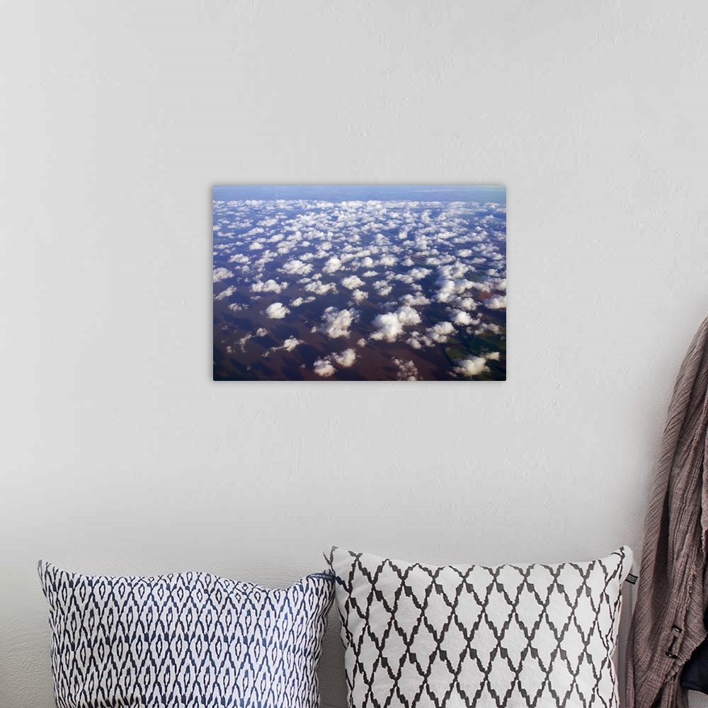 A bohemian room featuring Scattered clouds, aerial over Rio de la Plata, Argentina.