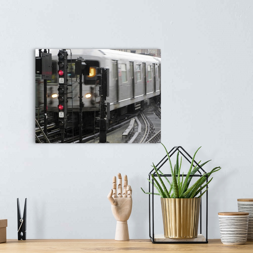 A bohemian room featuring Photograph taken of a subway train while it is in motion.