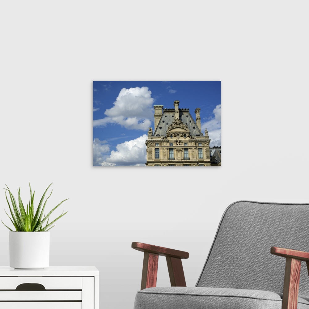 A modern room featuring The Louvre Museum in Paris, France, on a cloudy day