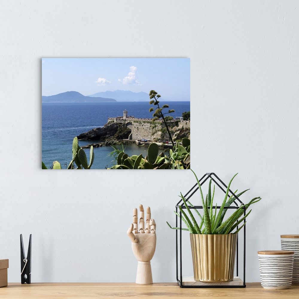 A bohemian room featuring Piombino, Tuscany coast in Summer time; Tyrrhenian sea. Ferry boat passing by, connecting mainlan...