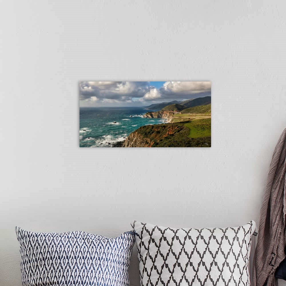 A bohemian room featuring A view of the Big Sur coastline from Hurricane Point, with the Bixby Creek Bridge glowing in the ...