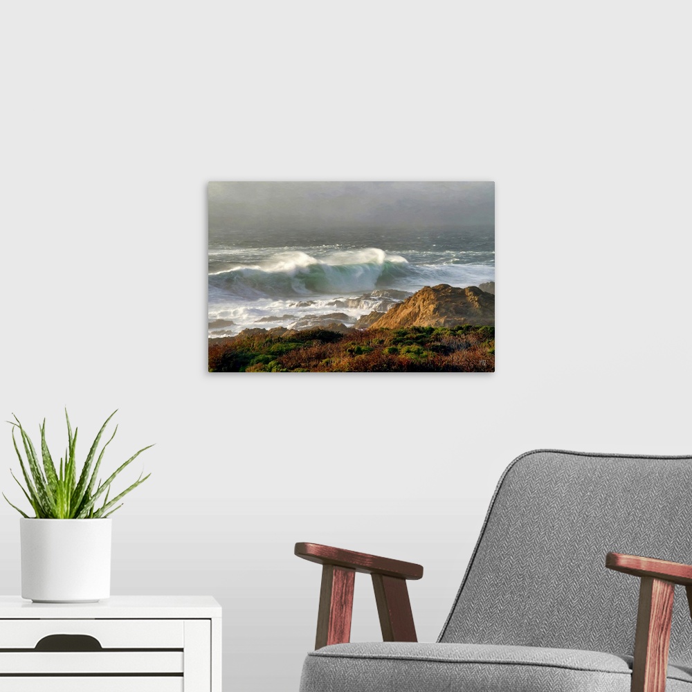 A modern room featuring A large wave rushes toward the Bir Sur shoreline as the sun breaks through receding fog. Inspired...