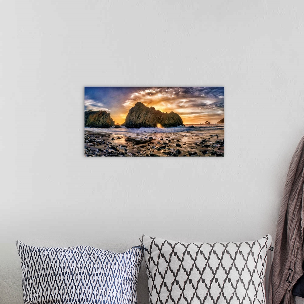A bohemian room featuring Rays from the setting sun light up the sky and shine a spotlight through the famed "Keyhole" rock...