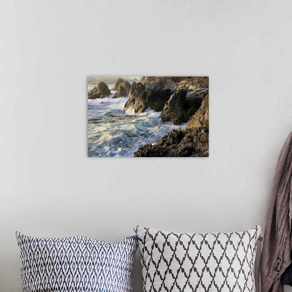 A bohemian room featuring Lying chest down on a rocky cliff about 40 feet above crashing waves, Michael Lynberg captured th...