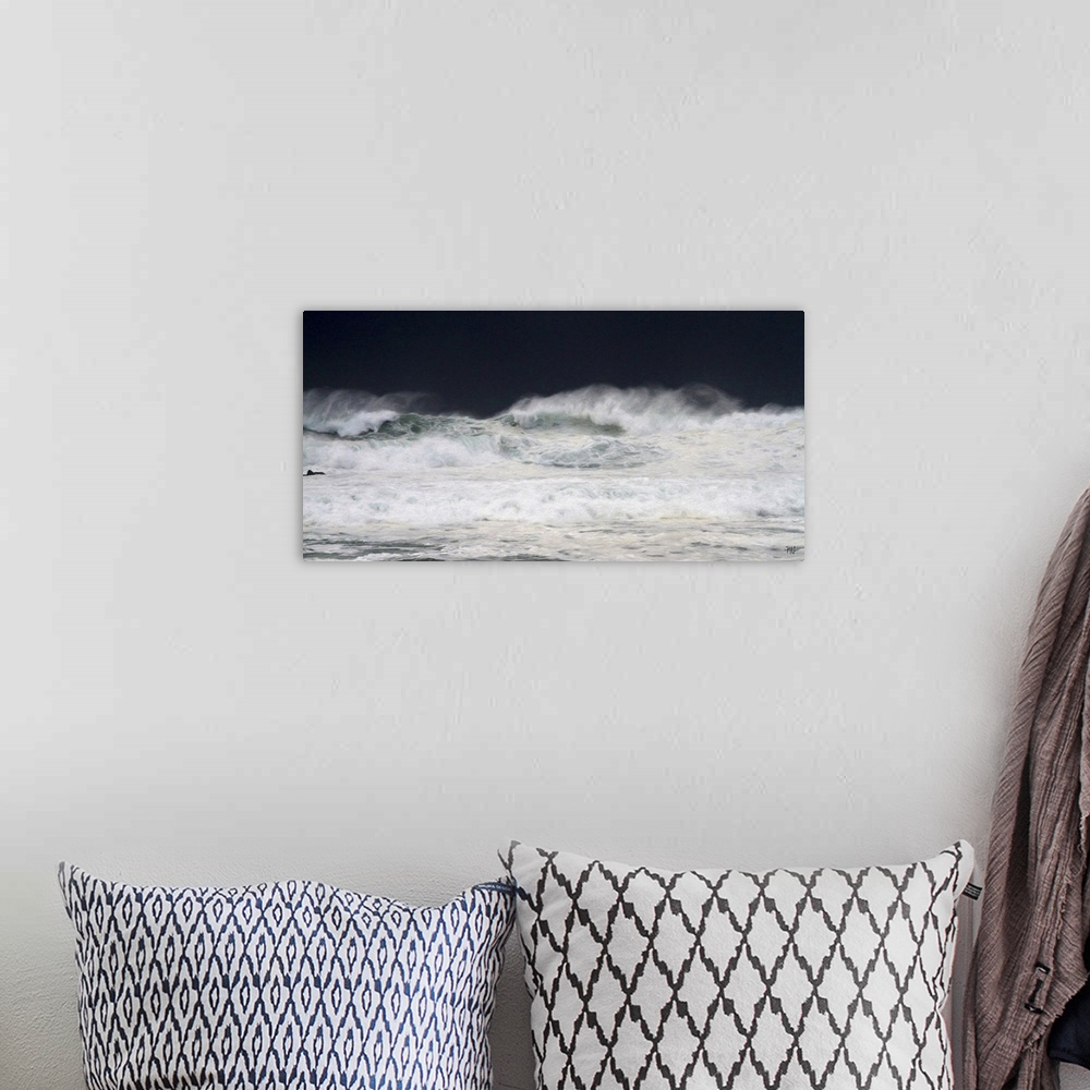 A bohemian room featuring Large waves crash toward the shore in Pebble Beach with storm clouds darkening the sky behind the...