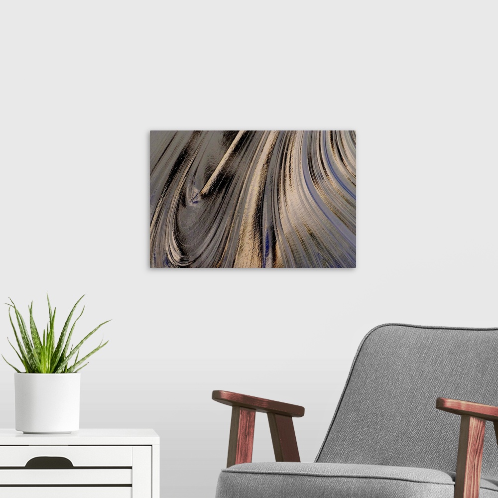 A modern room featuring A close up nature photograph of a light reflecting off oil creating abstract swirling movement.