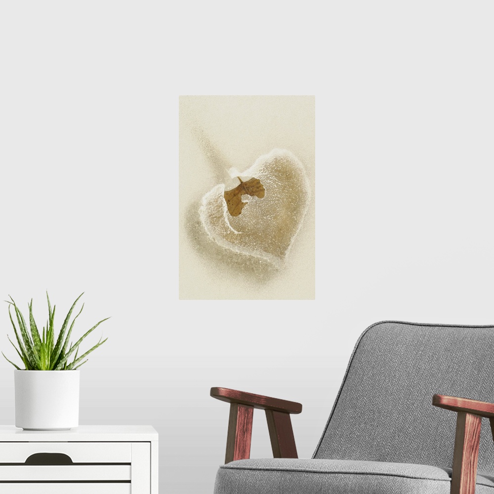 A modern room featuring This vertical wall hanging is a close up photograph of a leaf trapped in frozen water.
