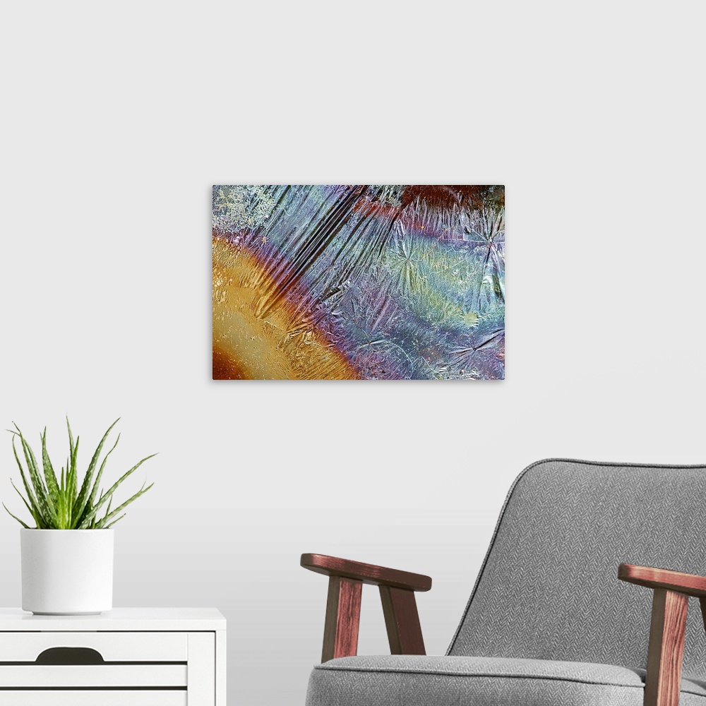 A modern room featuring Photograph of grease on top of a piece of rippled foil creating multicolored bands of color.